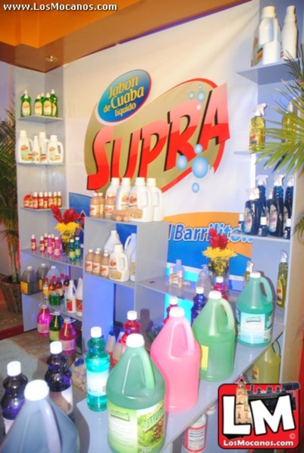 A store interior with numerous bottles and cans on shelves, featuring a Supra brand banner in the center and an LM logo in the bottom right corner.