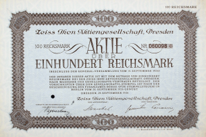 Ein altes deutsches Aktienzertifikat mit schwarzem Rand und der Aufschrift "Aktie über Einhundert Reichmark"
