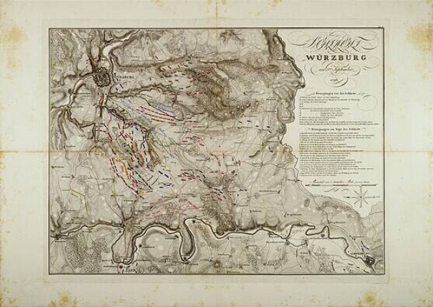 Ein detaillierter alter Stadtplan von Würzburg, Deutschland, der Straßen, Gebäude und Sehenswürdigkeiten zeigt, mit Text, der zusätzliche Stadtinformationen liefert.