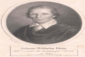 Schwarzes und weißes Porträt von Johann Wilhelm Klein, Direktor des Instituts für Blinde in Wien, der einen weißen Hemdkragen trägt und einen ernsten Gesichtsausdruck hat, mit deutschem Text unten.