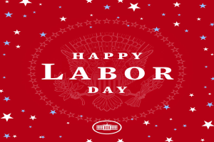 Plakat mit "Glücklicher Arbeitstag" in fetten weißen Buchstaben auf einem hellroten Hintergrund, umgeben von mehrfarbigen Sternen verschiedener Größen.