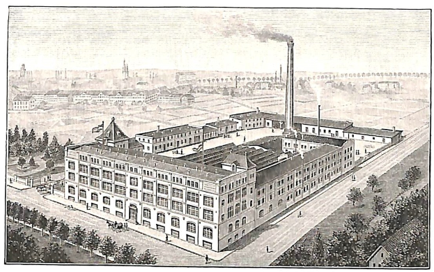 Alte Fabrik mit großem zentralen Gebäude umgeben von Bäumen, Text unten.